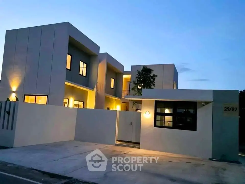Modern architectural exterior of a contemporary home with sleek design and ambient lighting.