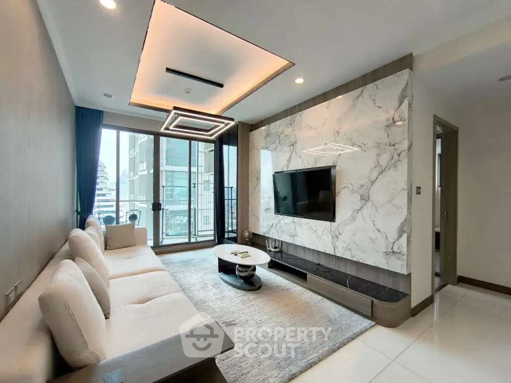 Modern living room with marble accent wall and city view balcony