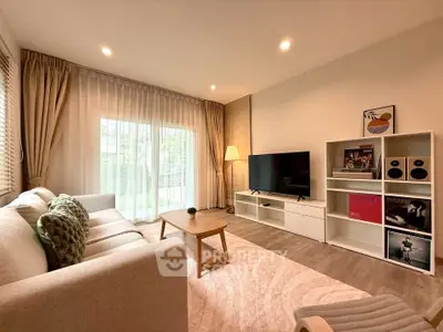 Modern living room with cozy sofa, stylish decor, and large window for natural light.