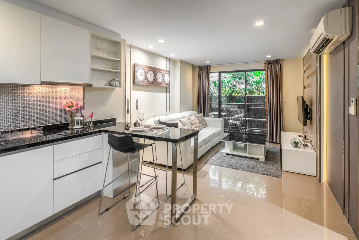 Modern open-layout living room with sleek kitchen and stylish decor