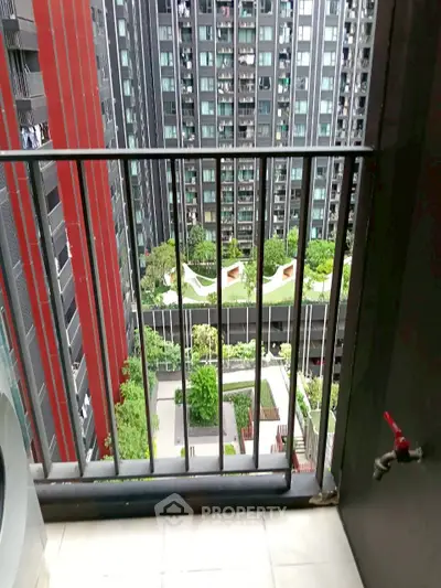 Stunning balcony view overlooking modern urban garden and high-rise buildings.