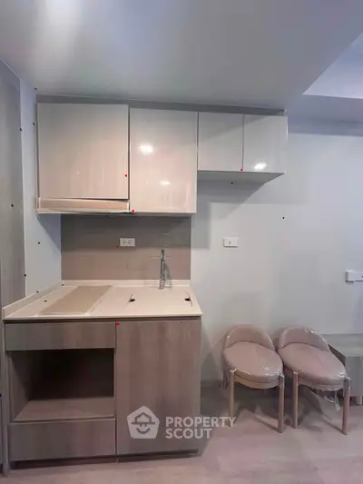Modern compact kitchen with sleek cabinetry and minimalist design