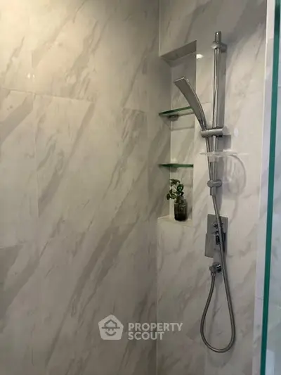 Modern bathroom shower with marble tiles and sleek fixtures