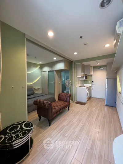 Modern studio apartment with stylish decor and compact kitchen