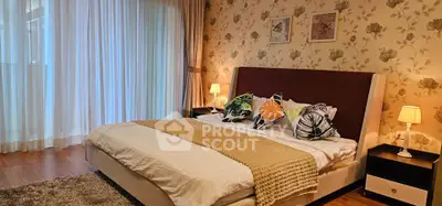 Luxurious bedroom with elegant decor and large windows in a modern apartment.