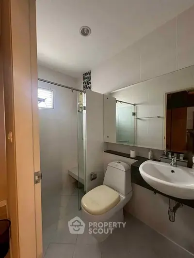 Modern bathroom with sleek fixtures and glass shower enclosure