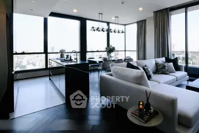 Luxurious modern living room with panoramic city views and elegant furnishings.