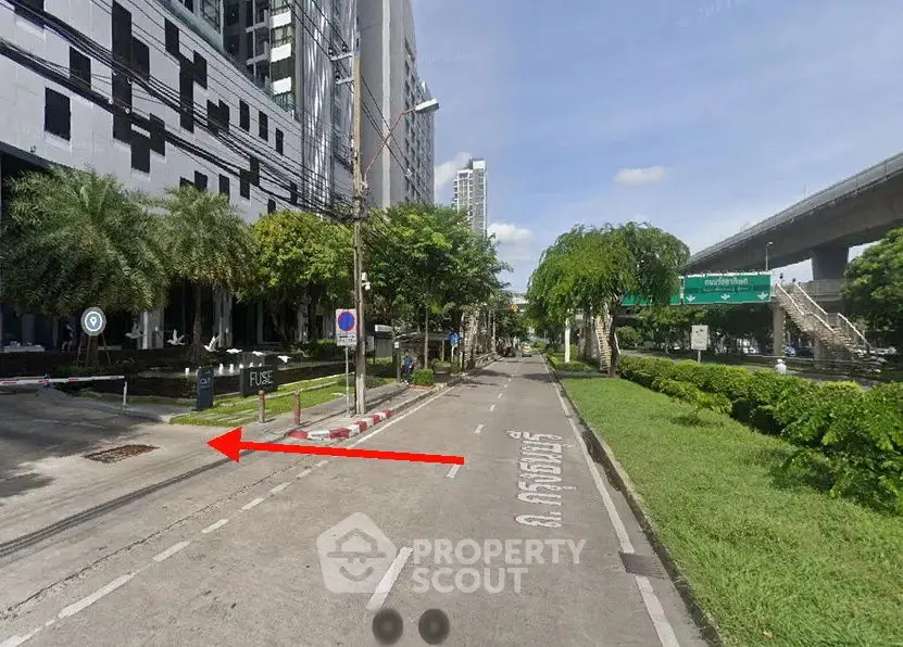 Modern urban street view with high-rise buildings and lush greenery