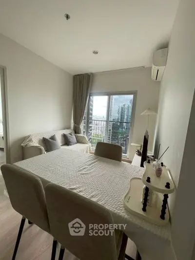 Cozy living room with dining area and city view from balcony