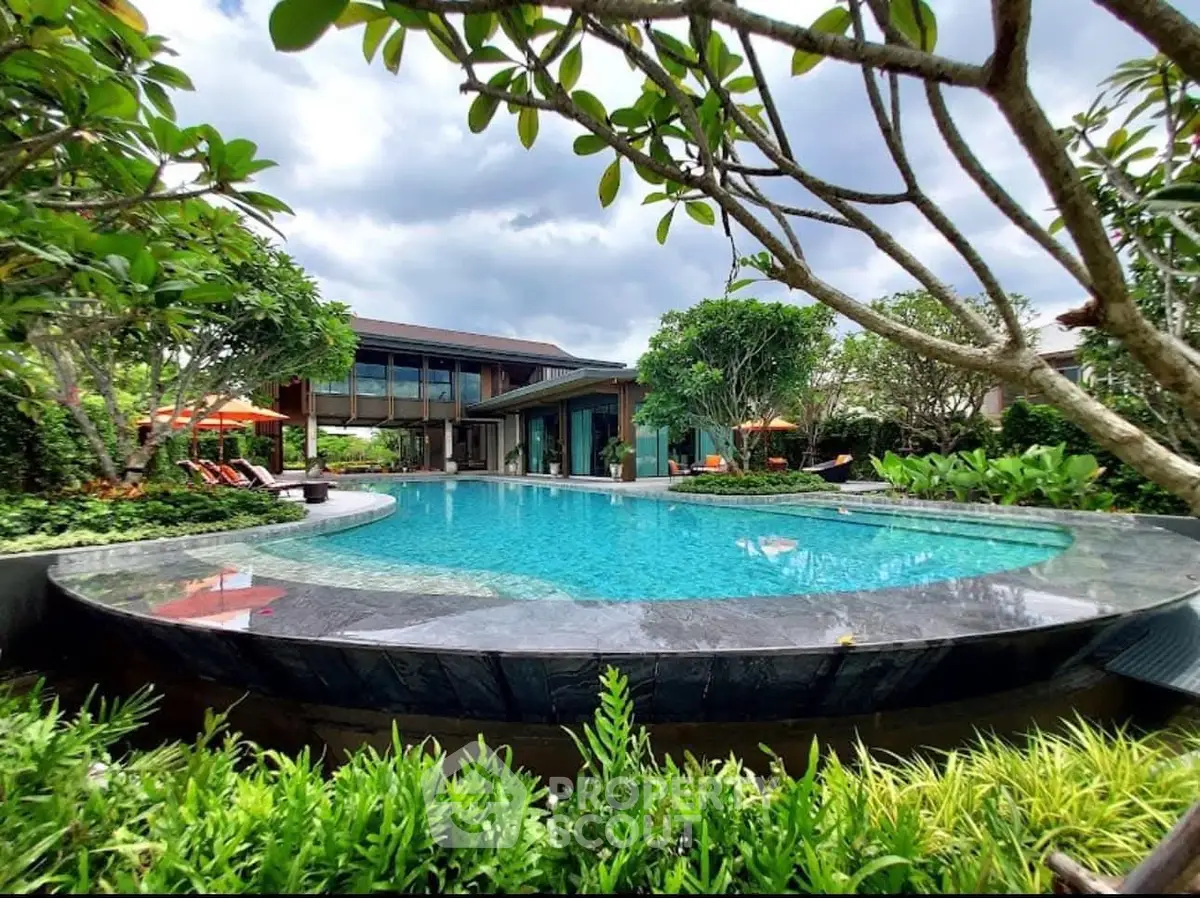 Luxurious modern villa with stunning pool and lush garden landscape.