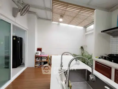 Modern kitchen with open layout and sleek design, featuring a spacious countertop and contemporary appliances.