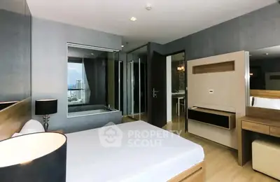 Modern bedroom with sleek design and city view, featuring stylish furniture and large window.