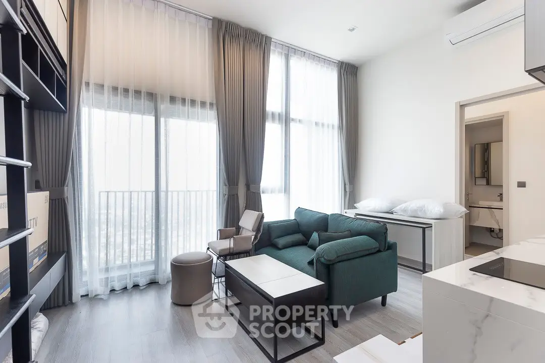 Modern living room with high ceilings and large windows, featuring elegant furniture and a sleek design.