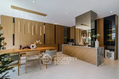 Modern kitchen with sleek design and open layout, featuring wooden accents and contemporary furniture.