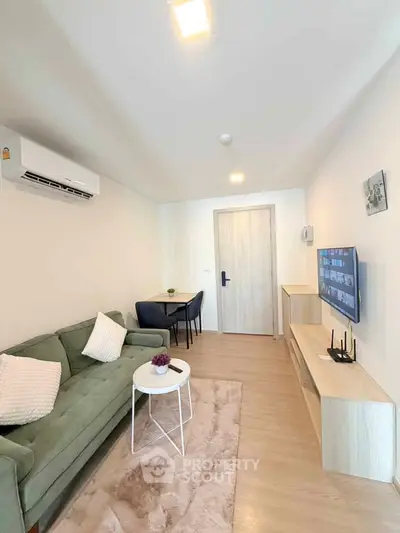 Modern living room with stylish furniture and wall-mounted TV, perfect for cozy relaxation.