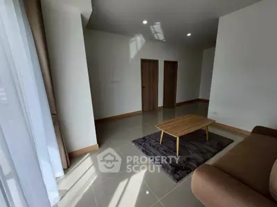 Spacious living room with modern decor and natural light