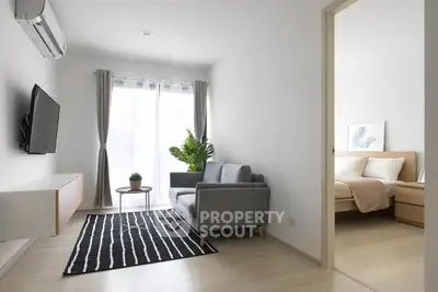 Modern living room with sleek furniture and natural light in a stylish apartment.