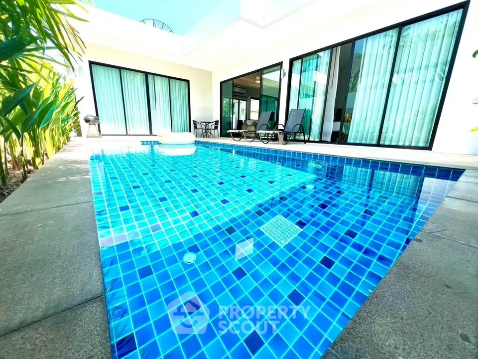 Luxurious villa with private pool and modern glass doors, perfect for relaxation and entertainment.