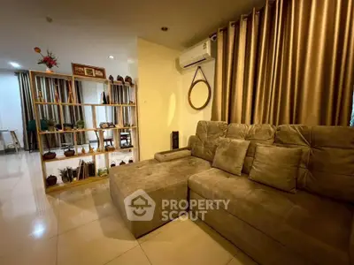 Spacious living room with elegant decor and plush sofa in modern apartment.