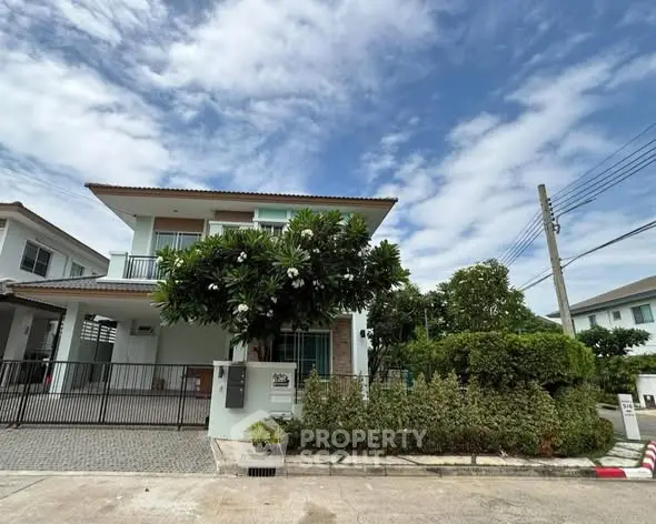Charming two-story house with lush garden and modern design in a serene neighborhood.