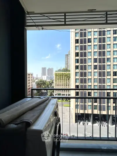 Modern balcony view with cityscape and washing machine setup