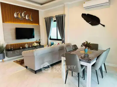 Modern living room with elegant decor, featuring a cozy sofa, wall-mounted TV, and stylish dining area.