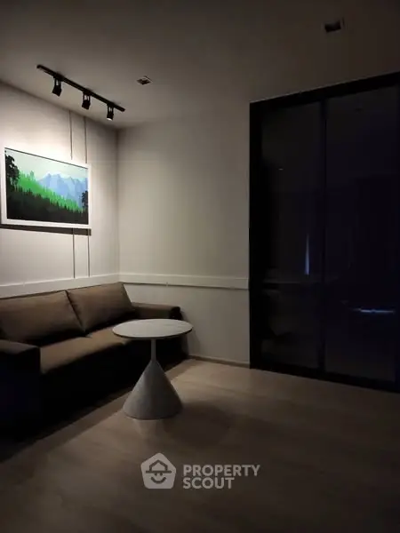 Cozy living room with modern sofa and stylish artwork, perfect for relaxation.