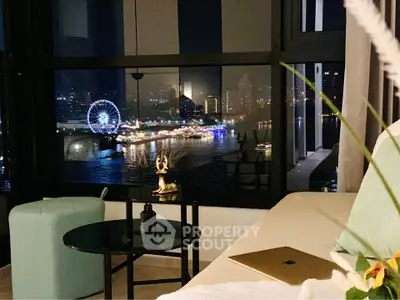 Luxurious living room with stunning city and river view, featuring modern decor and cozy seating area.