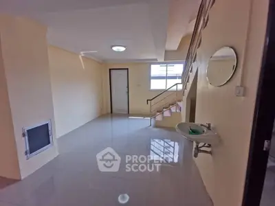 Spacious interior with staircase and modern fixtures, ideal for stylish living.