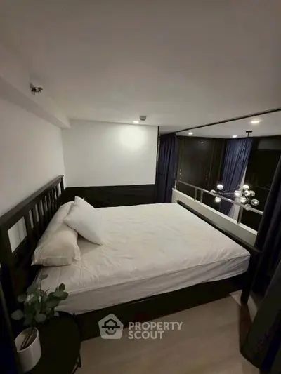 Modern bedroom with stylish decor and large windows offering natural light
