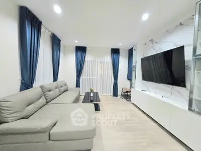 Spacious modern living room with elegant decor and large TV