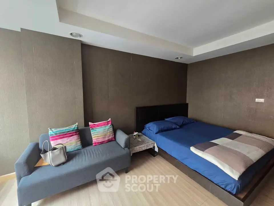 Modern bedroom with stylish decor and cozy seating area