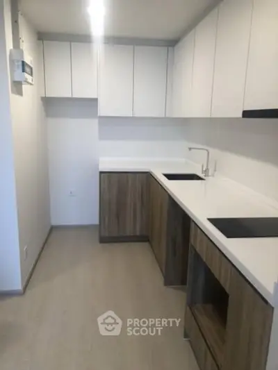 Modern kitchen with sleek cabinetry and minimalist design in a contemporary apartment.