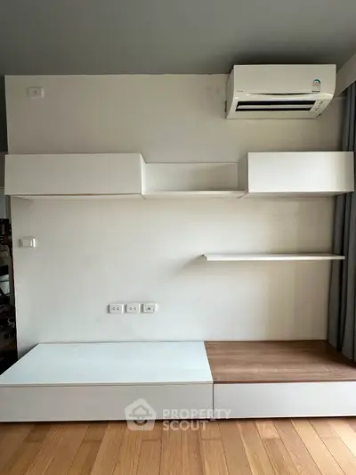 Modern minimalist interior with built-in storage and air conditioning unit