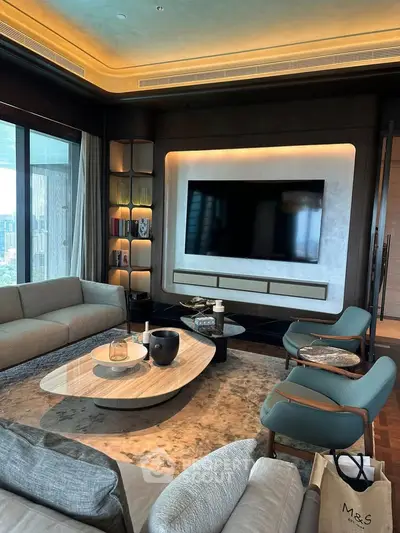 Luxurious modern living room with elegant furniture and large TV, offering a sophisticated ambiance.