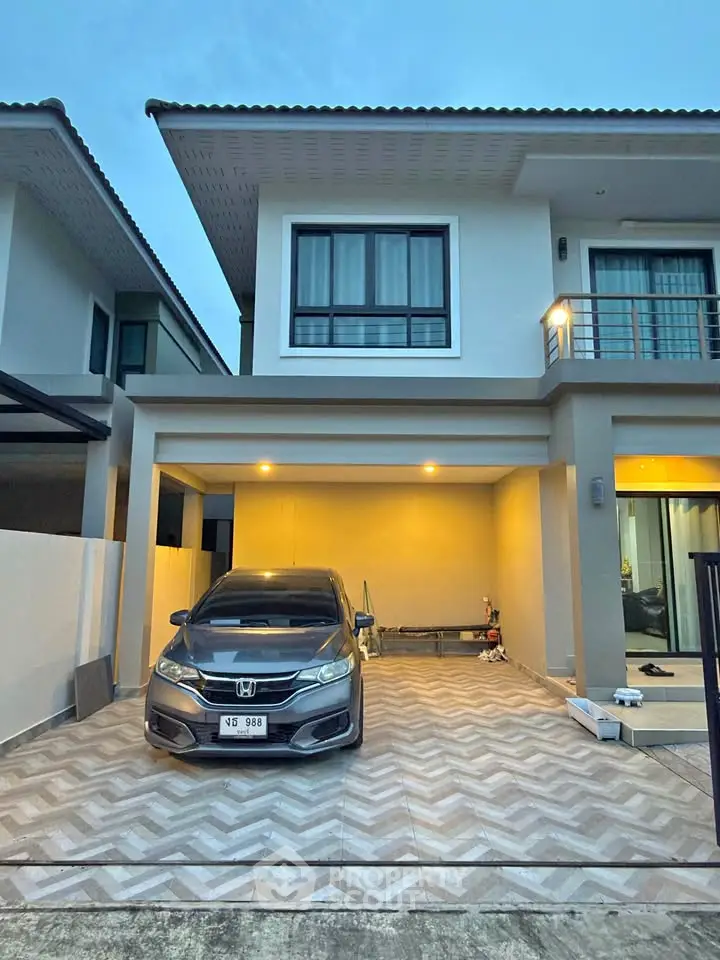 Modern two-story house with garage and parked car in a suburban neighborhood.