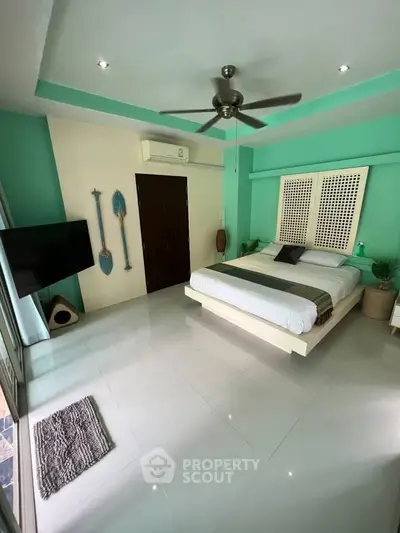 Spacious bedroom with modern decor and ceiling fan, featuring a cozy bed and stylish accents.