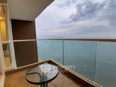 Stunning ocean view from a modern glass balcony, perfect for relaxation and enjoying the serene seascape.
