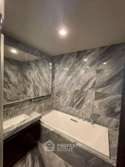 Luxurious marble bathroom with elegant bathtub and modern fixtures