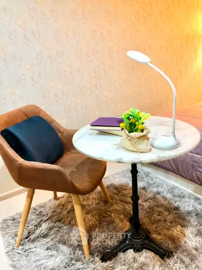 Cozy bedroom corner with stylish chair and elegant table lamp