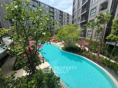 Luxurious apartment complex with stunning pool and lush greenery, perfect for relaxation and leisure.