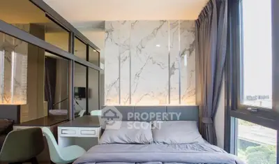 Modern bedroom with marble accent wall and large window offering city views.