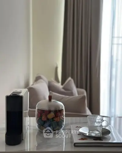 Cozy living room corner with coffee machine and plush sofa