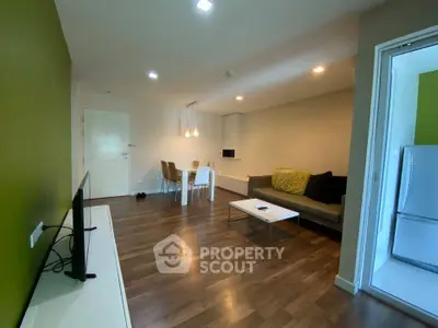 Modern living room with wooden flooring and stylish furniture in a cozy apartment.