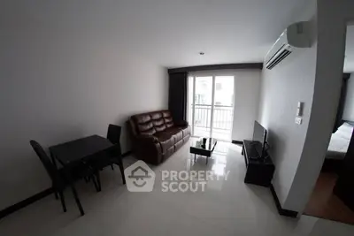 Modern living room with sleek furniture and balcony access in a stylish apartment.