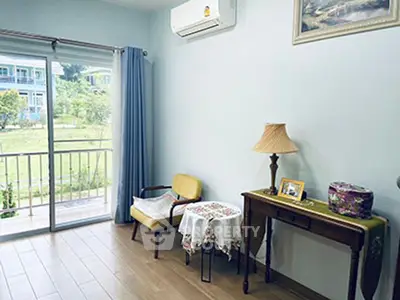 Charming living room with balcony view and elegant decor