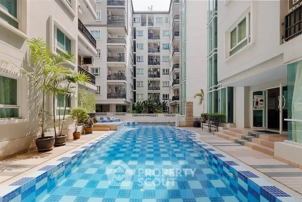 Luxurious apartment complex with a stunning outdoor pool and modern architecture.
