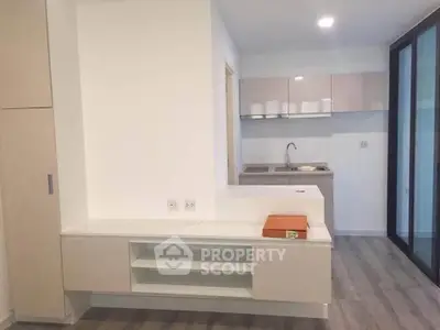 Modern kitchen with sleek cabinetry and open layout in contemporary apartment.