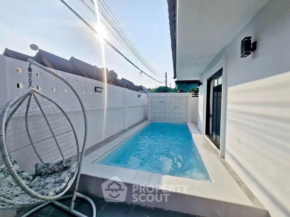 Charming private pool area with modern design and cozy seating, perfect for relaxation.