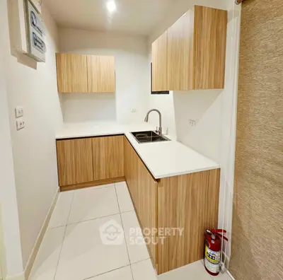 Modern kitchen with sleek wooden cabinets and white countertops